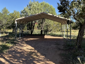 Relax under the shade of this open pavilion surrounded by lush trees and greenery.