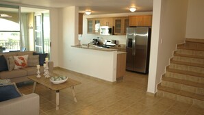A modern kitchen with a central island, stainless steel appliances, and wooden cabinets. - PENTHOUSE CONDO | BEAUTIFUL | 3 BEDS | 3 BATHS | 2 LEVELS | MAGNIFICENT VIEWS (Fajardo)