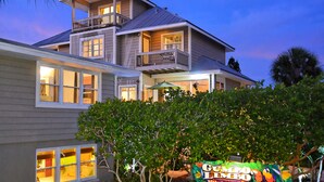 A two-story building with multiple windows, a balcony, and a sign for 'Gumbo Limbo'. - 🌷Steps to Siesta Beach, Chic Studio, Pool & Patio (Siesta Key)