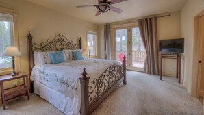 A bedroom with a bed, a ceiling fan, a TV on a stand, and a window with curtains. - Luxury Cabin - views, location, perfect for families, 4 miles from Breckenridge (Blue River)