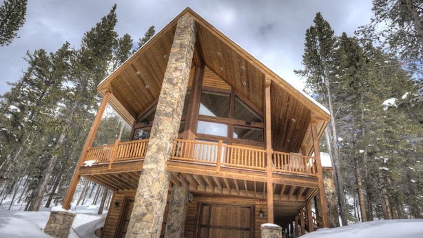 A wooden cabin with a balcony, stone pillars, and a large wooden door. - Luxury Cabin - views, location, perfect for families, 4 miles from Breckenridge (Blue River)