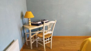 A small room with a wooden floor, a white desk with a lamp, a chair, and a radiator. - country holiday home - in Champagne - Trélou sur Marne (Trélou-Sur-Marne)