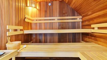A sauna with wooden benches and a wooden bowl.