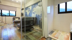 A modern living room with a sofa, a small table, and a world map on the wall. - B&B Mountain View (Xincheng)