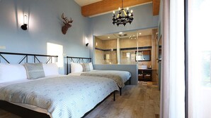 A bedroom with two beds, a chandelier, a deer head decoration, and a bathroom visible through a glass door. - B&B Mountain View (Xincheng)