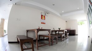 A spacious room with a curved ceiling, a wooden table set, and a calendar on the wall. - Weerawan Place (Khon Kaen)