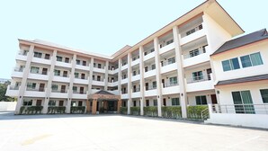 A multi-story hotel with a central courtyard, balconies, and a sign indicating it is a hotel. - Weerawan Place (Khon Kaen)