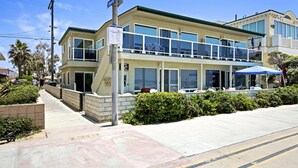 A two-story building with a ground-level restaurant and upper-level residential units. - Affordable and ocean front! (San Diego)
