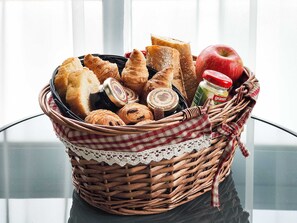 Freshly baked treats and sweet accompaniments are offered in a charming basket.