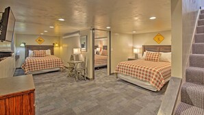 A hotel room with two beds, a desk, a chair, and a staircase. - Charming Home - 1 Mi to Yellowstone National Park! (West Yellowstone)