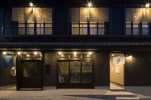 A traditional building with a dark wooden facade, large glass doors, and a small entrance with steps. - Arimakoyado HATAYA (Kobe)