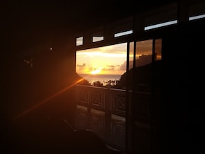 Enjoy breathtaking ocean views from the balcony with a railing, overlooking the distant shoreline.