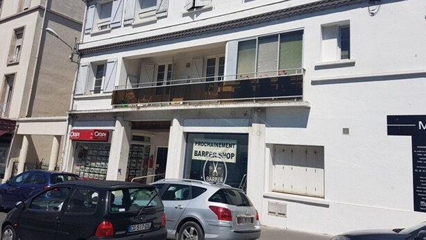 A two-story building with a barbershop on the ground floor.