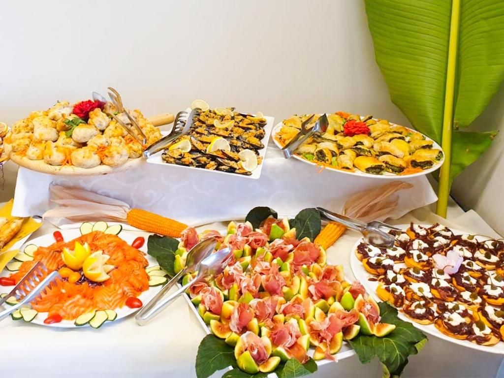 A table with various food platters, including seafood, salads, and appetizers.