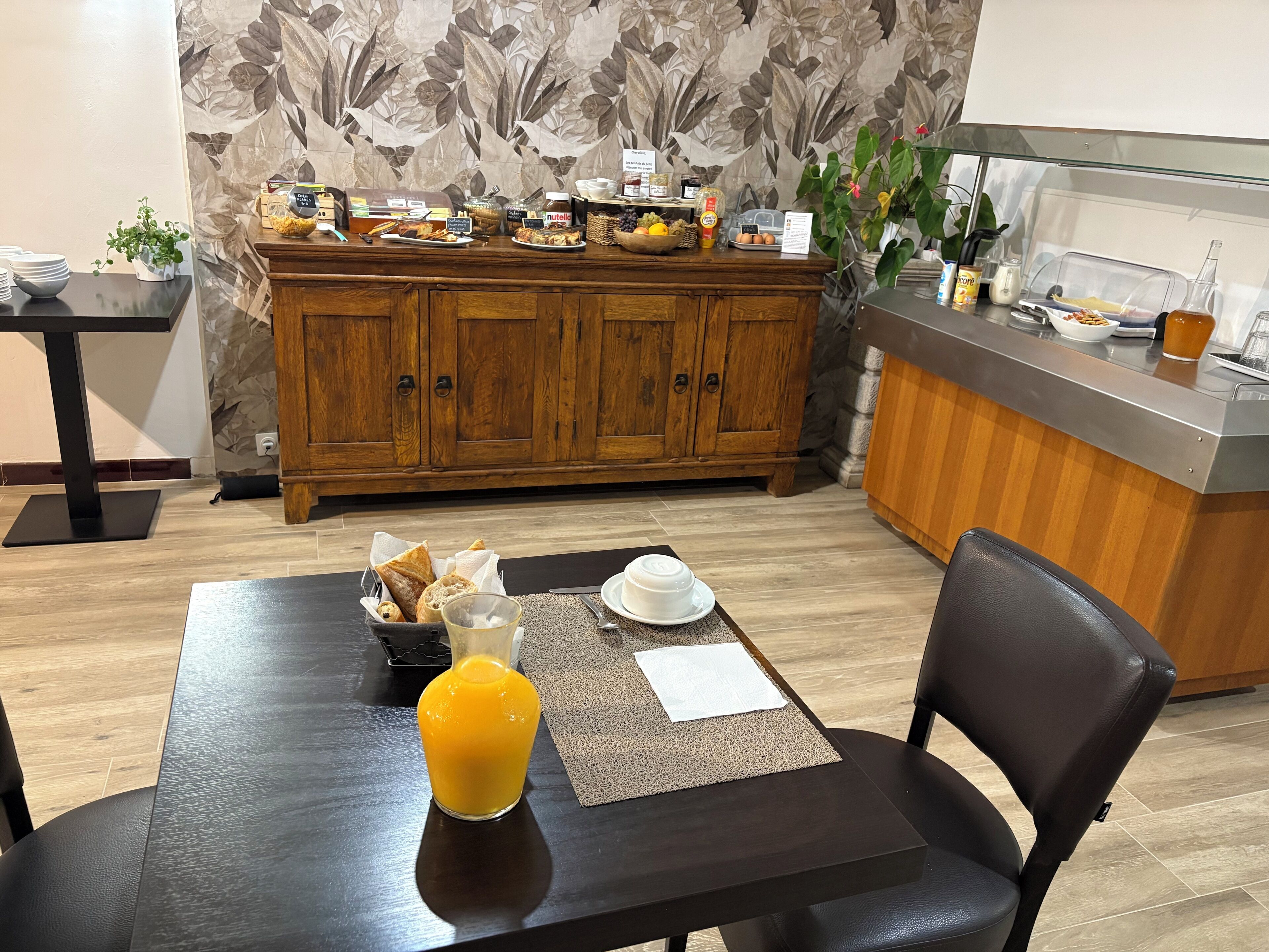 A breakfast buffet with various food items and a coffee station.