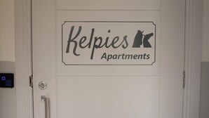 A white door with a sign that reads "Kelpies Apartments." - Kelpies Serviced Apartments (Falkirk)