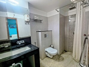 A bathroom with a sink, toilet, and shower.