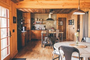 A wooden interior with a dining area, kitchen, and a wooden ceiling. - Artisan-crafted Magic on Lake Superior (Lutsen)
