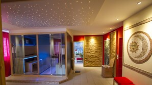 A modern interior with a glass partition, a red bench, and a decorative wall piece. - Seehotel Plau Am See (Plau am See)