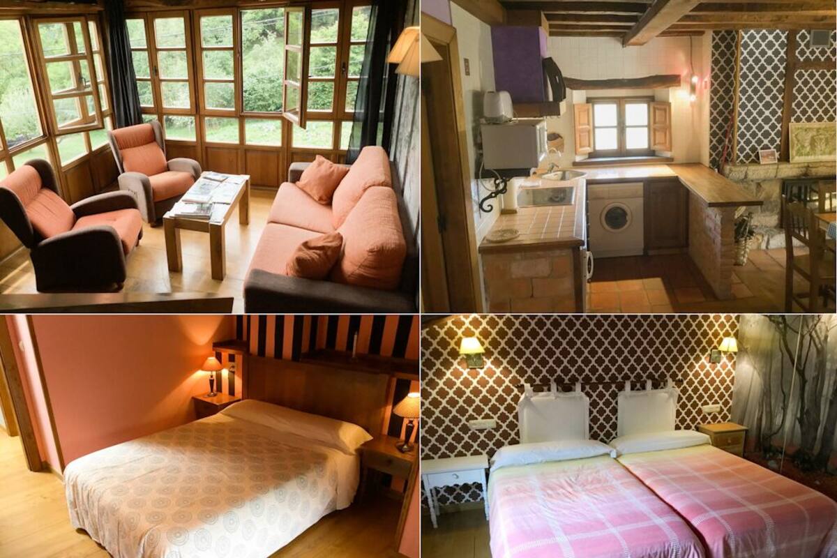 A cozy room with a sofa and armchairs, a separate bedroom with a bed, and a kitchen area with a washing machine.