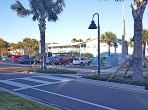 Stroll along the sidewalk lined with palm trees and enjoy the view from the balcony of this charming hotel.