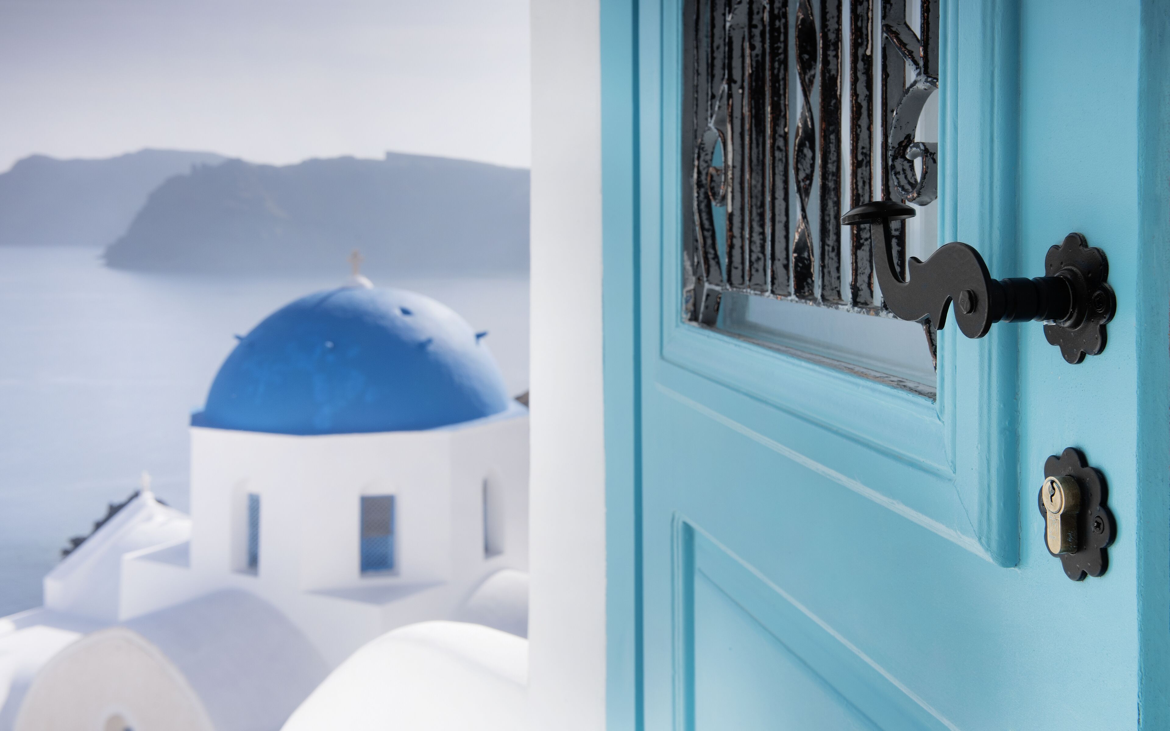 A blue door with a keyhole and a metal latch.