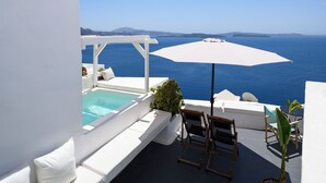 A rooftop terrace with a pool, white furniture, and a view of the sea. - Sophia Oia View (Santorini)