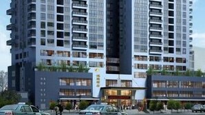 Un immeuble moderne à plusieurs étages, doté de nombreux balcons et de grandes fenêtres.