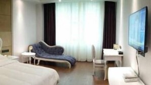 A hotel room with two beds, a desk, a chair, and a TV. - Chenmao Yuyang Hote (Guigang)
