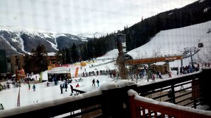 A ski resort with a dining area, ski lifts, and a mountain backdrop. - Our studio condo is the closest condo to the Eagle Lift.  Just steps away. (Frisco)