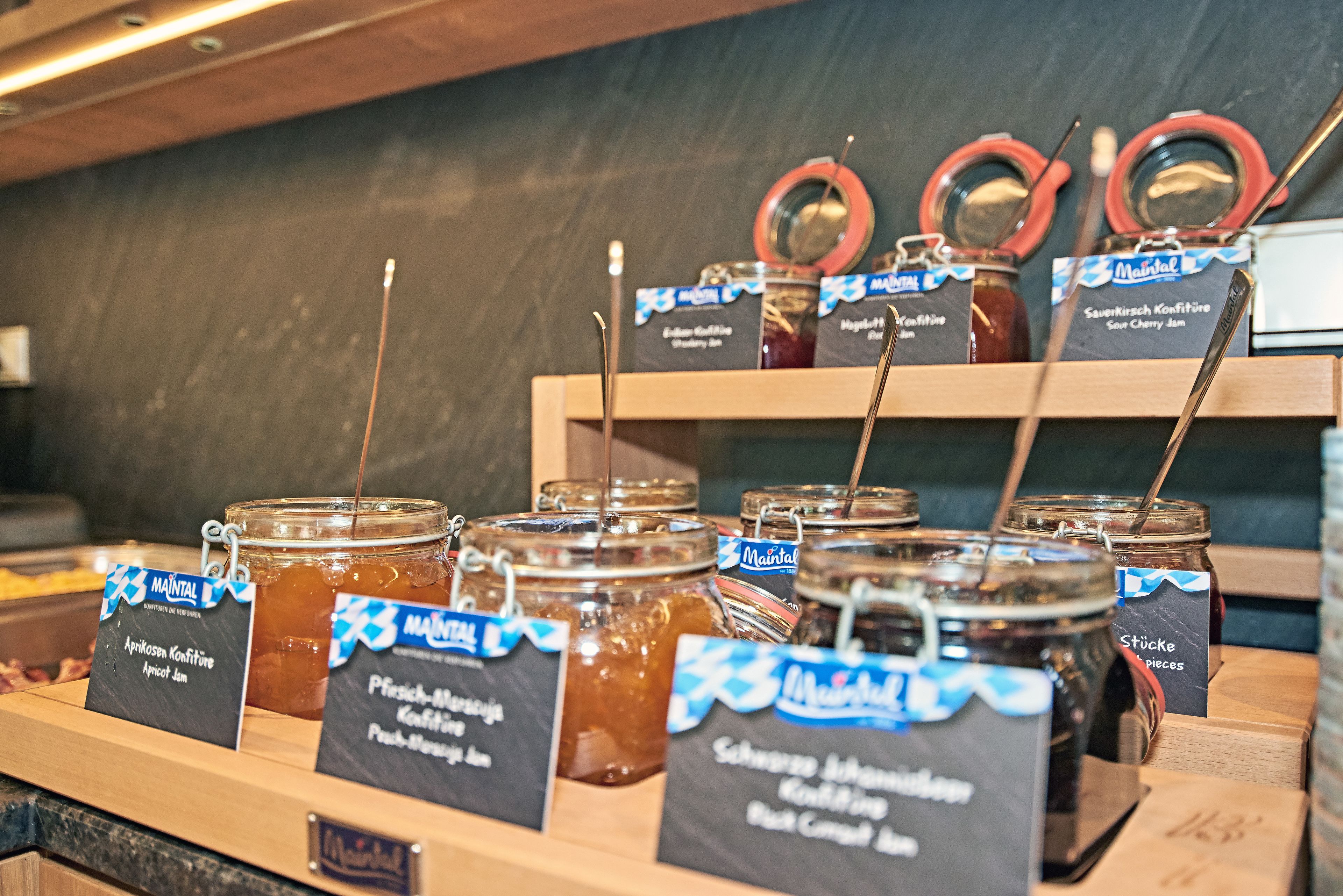 A display of various jams with labels in a store.