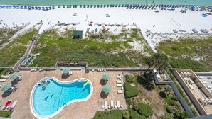 A beach resort with a swimming pool, beach umbrellas, and lounge chairs. - BEACHFRONT-9th floor view, recently updated-avail Sept 7-12, 19-23, Oct 18-25 (Destin)