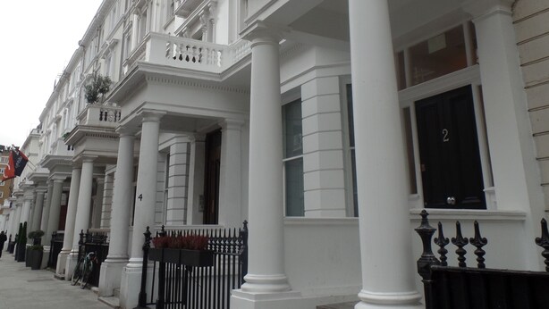 A row of white buildings with classical architecture, featuring columns and large windows. - QB 11 (London)