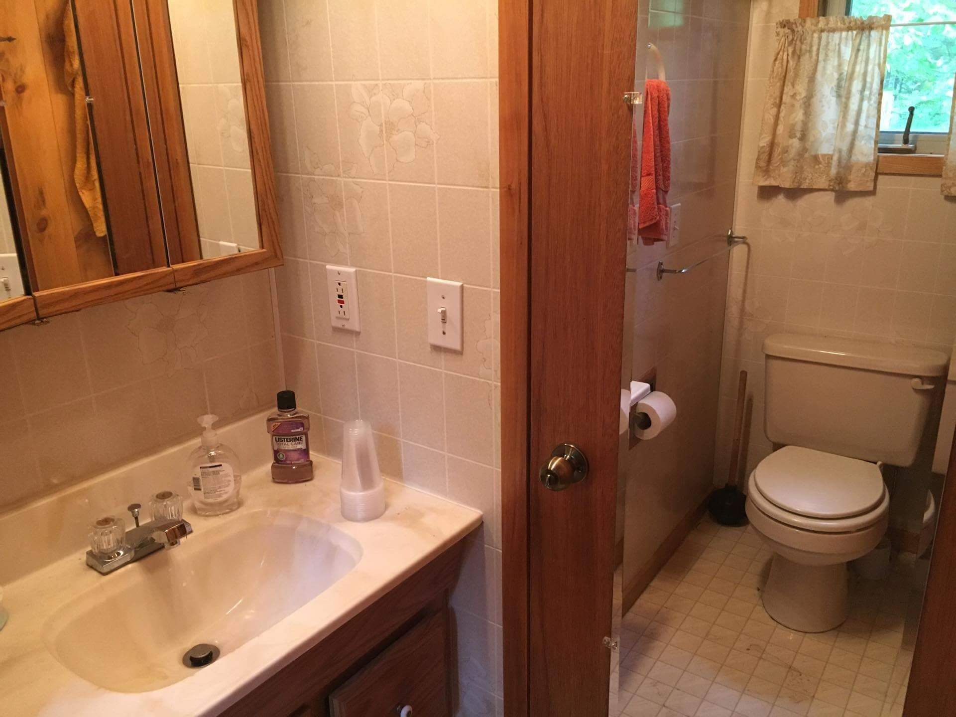 Ein Badezimmer mit Waschbecken, Toilette und Duschbereich.