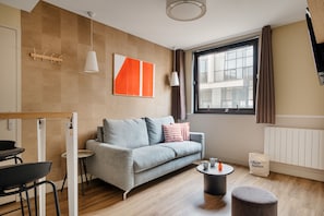 Cosy One-Bedroom Apartment - Street View | Living area | 30-cm TV with cable channels - Edgar Suites Expo Paris Porte de Versailles (Paris)