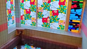 A pool with colorful stained glass windows reflecting on the water. - Pension A Million Roses (Shimoda)