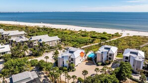 A coastal resort with multiple buildings, a swimming pool, and a beach. - 🌺Bandy Beach A101: Brand-New Beachfront Oasis w/ Dual Kings & Pool🌴 (Sanibel)