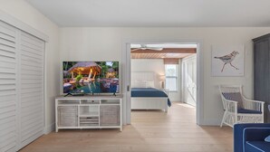 A modern living room with a television, a bed, and a chair. - 🌺Bandy Beach A101: Brand-New Beachfront Oasis w/ Dual Kings & Pool🌴 (Sanibel)