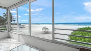 A room with large windows overlooking a beach. - Island House Beach Resort 3N (Siesta Key)