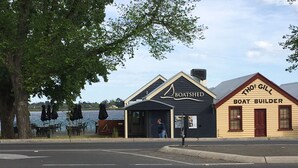 A waterfront restaurant named Boatshed with outdoor seating and a boat building shop named Thos Gill Boat Builder. - Central, Classic, Contemporary , Comfortable, Convenient , Charming (Ballarat Central)