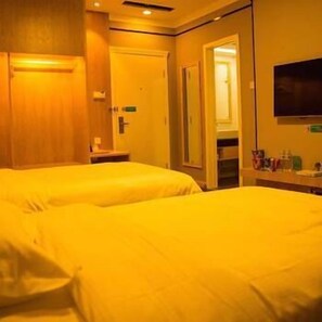 A hotel room with two beds, a TV mounted on the wall, and a bathroom visible through an open door. - Shanghui Hotel (Weifang)