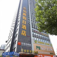 A hotel building with multiple signs, including one for a coffee shop and another for a store.
