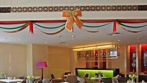 A hotel lobby with a reception desk, seating area, and a bar. - Harbour City Hotel (Jingmen)
