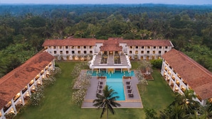 A large resort with a central pool, surrounded by lush greenery and multiple guest buildings. - Heritance Ayurveda (Beruwala)