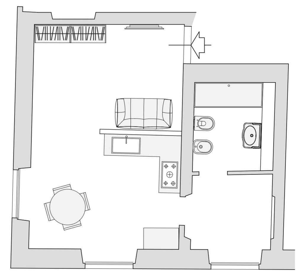 Un plan d’étage d’une chambre d’hôtel comprenant un coin cuisine, un espace repas et une salle de bain.