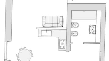 A floor plan of a hotel room with a kitchenette, a dining area, and a bathroom.