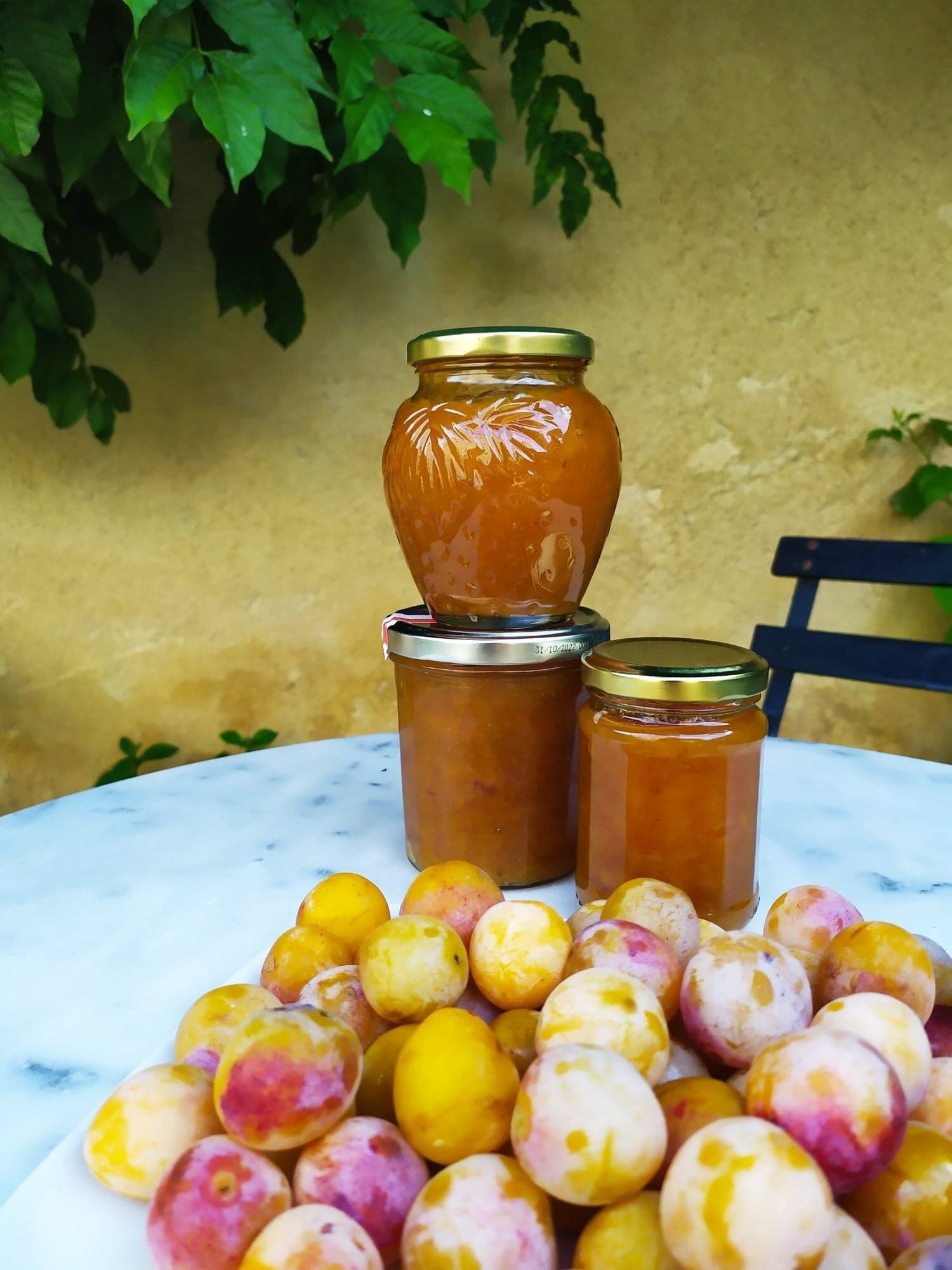 A table with jars and plums.