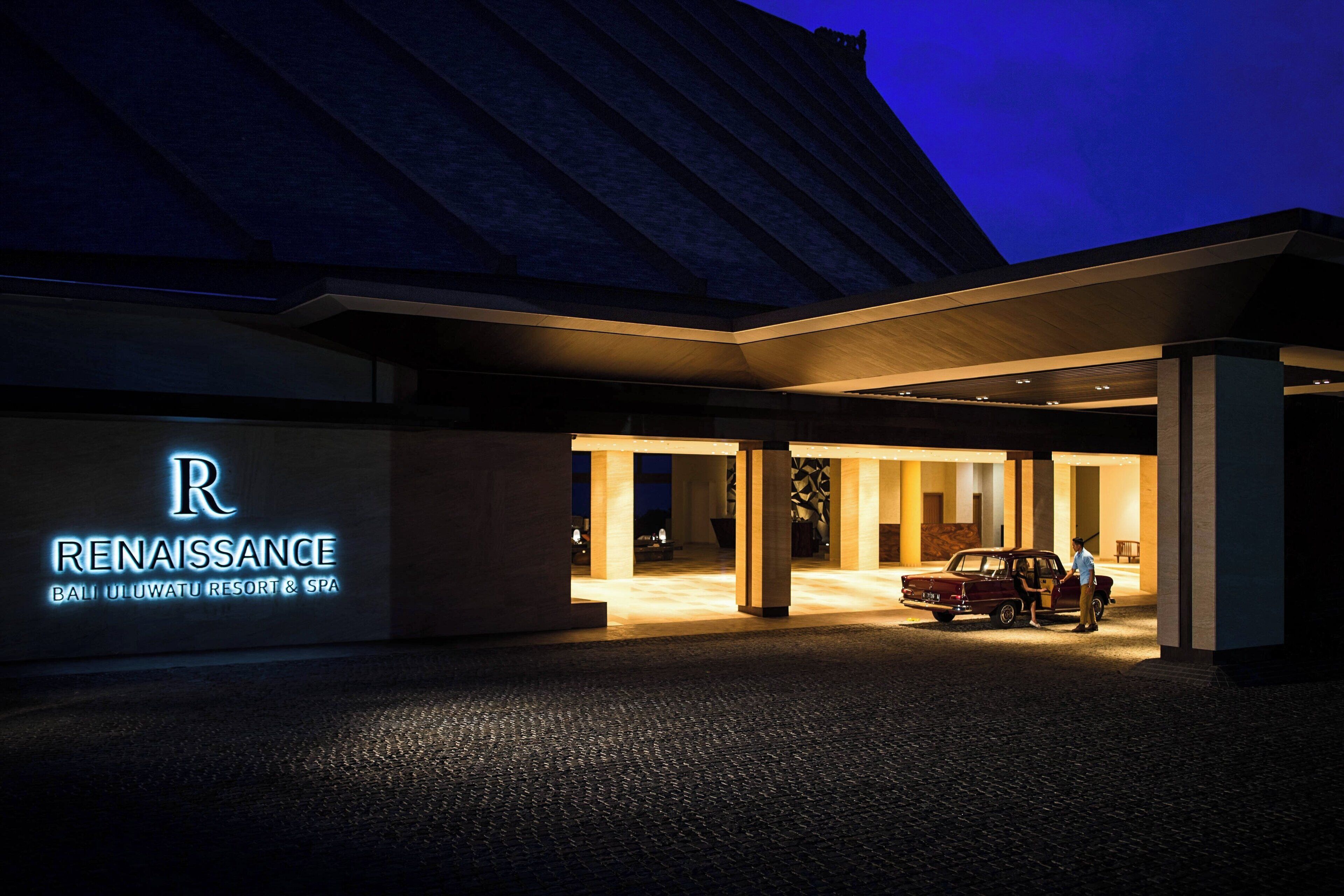 A modern building with a prominent illuminated sign reading "Renaissance Bali Uluwatu Resort & Spa."