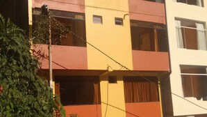 A multi-story building with a sign reading "HOSTAL" indicating it is a hostel. - Hostal Vista Waynapata (Machu Picchu)