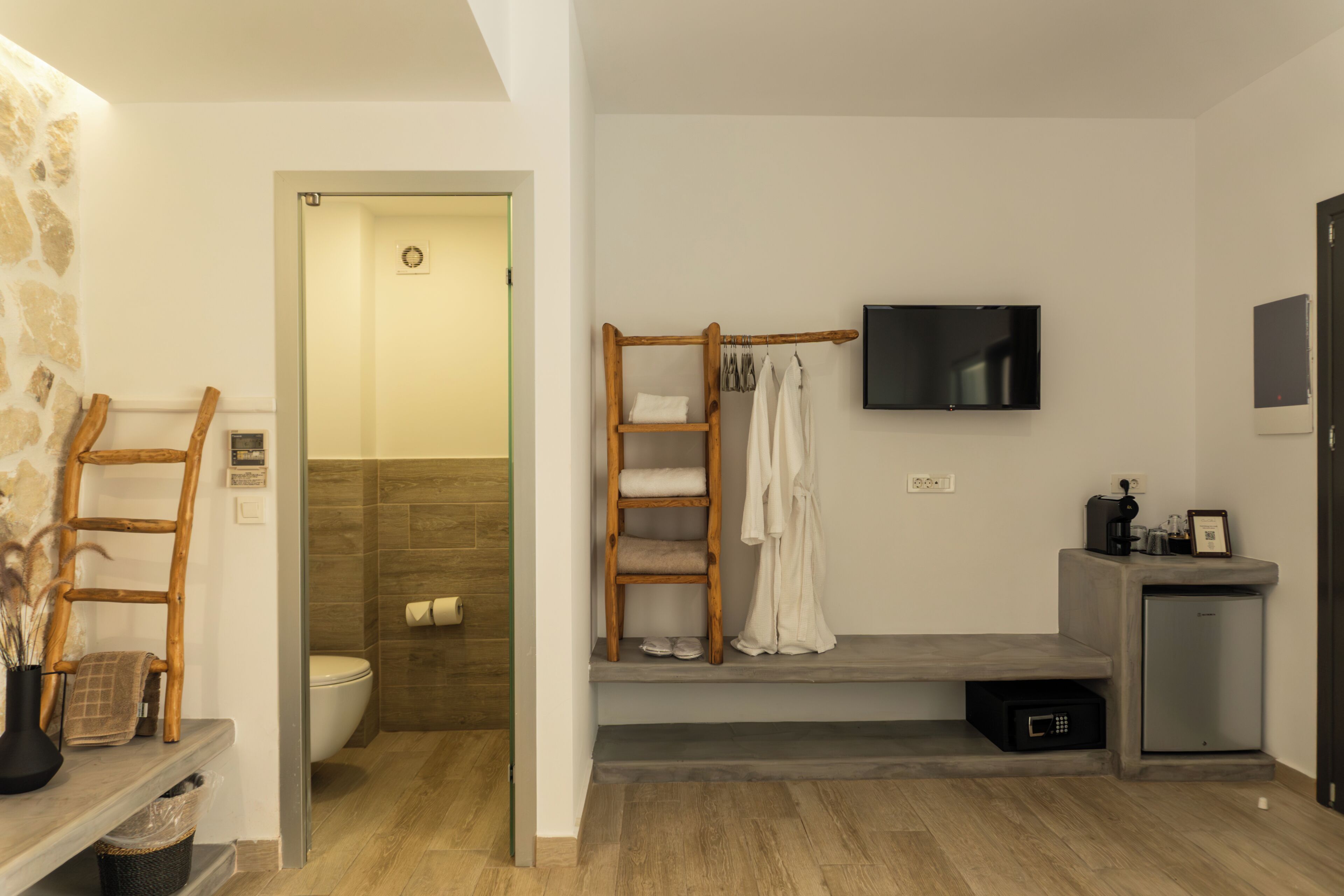A modern bathroom with a shower, toilet, and a vanity area.